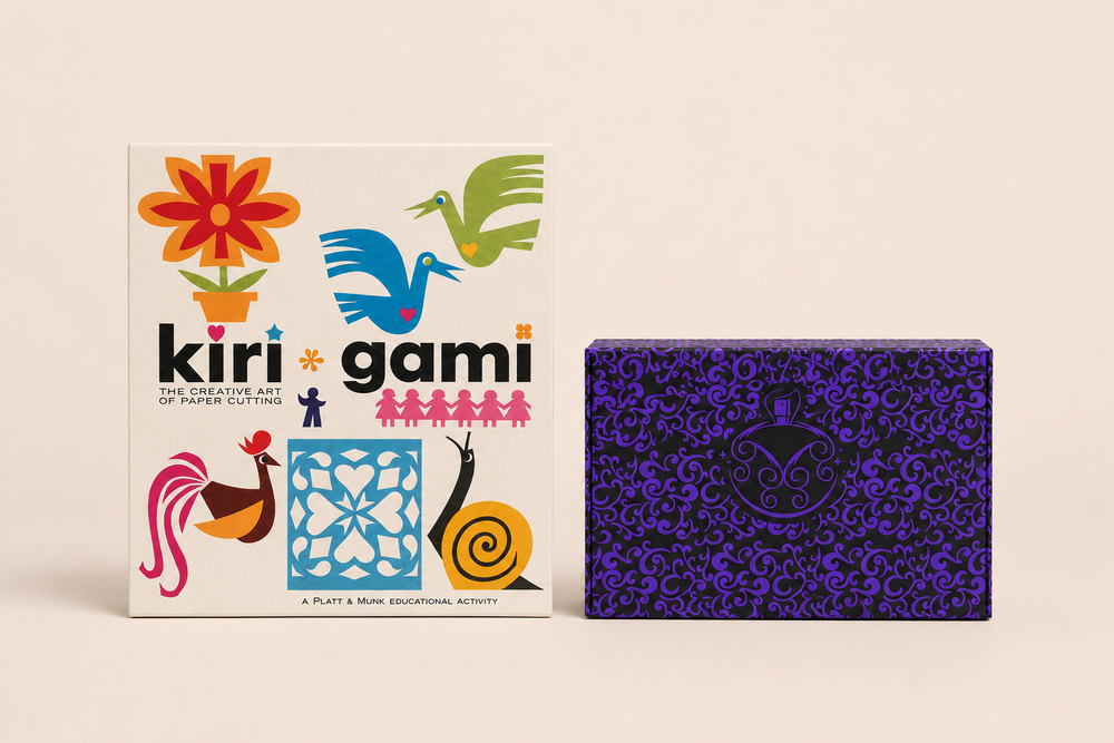 Two boxed kits side by side: a vintage kirigami paper-cutting kit and the violet patterned Lucullion perfume kit